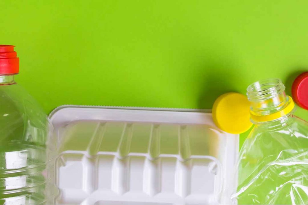 Mixed plastics on a green background.