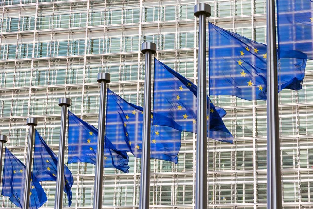EU flags outside the European Commission building in Brussels, Belgium.