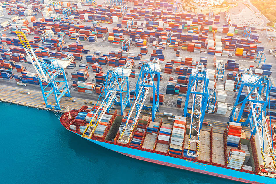 Cargo ship docked at logistics hub.