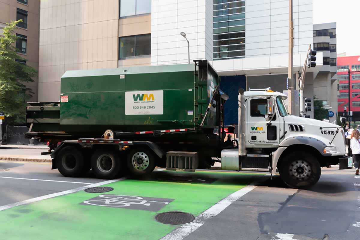 WM truck on a city street.